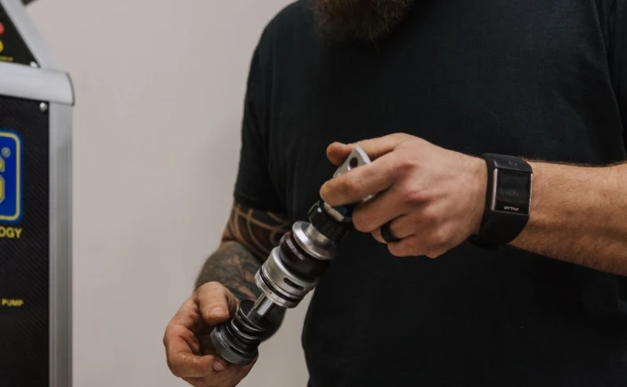 Man holding motorcycle shock